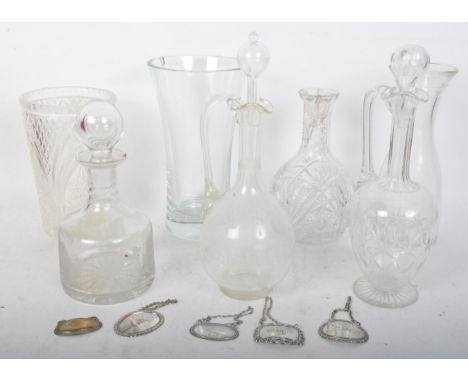 A collection of assorted vintage 20th Century glass decanters vases and wine jug. Some with stoppers and silver name chains. 