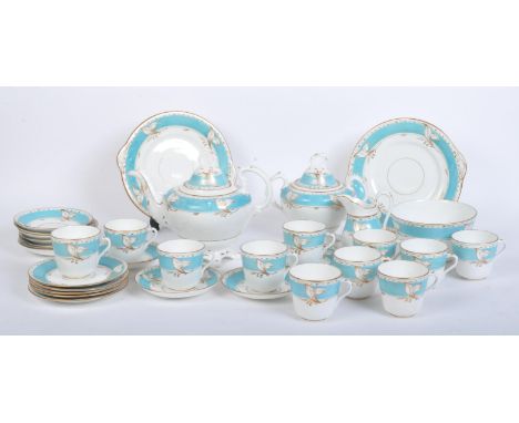 A Victorian 19th century circa 1900 English porcelain tea set. The tea service having a light blue ban with foliate gilt deco