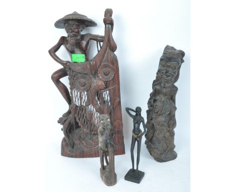 Two 20th century African tribal carved hardwood statues comprising of a fisherman figure with hat &amp; net, together with a 