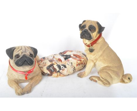 Two large vintage 20th century Country Artists figures in the form of pug dogs, with one being depicted laying down and the o