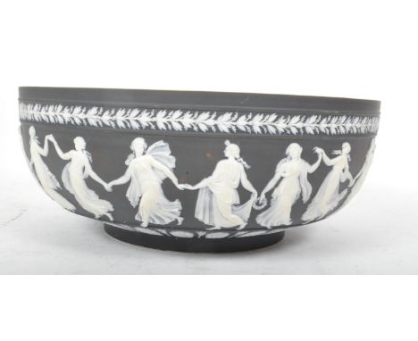 A vintage 20th century Wedgwood jasperware dip asphalt black centrepiece bowl being decorated in relief with classical dancer