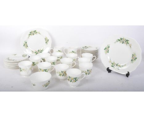 A vintage 20th century Royal Tuscan bone china twelve person tea service comprising of teacups, saucers, side plates (trios),