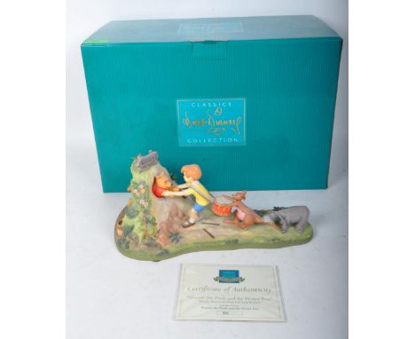 A 20th century Walt Disney Classics Collection ceramic figure of "Winnie The Pooh and the Honey Tree" Hooray, Hooray, for Poo
