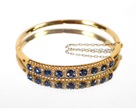 A yellow metal sapphire and diamond set bangle, approx. 13.5gms total weight - see further images for jewellers report 