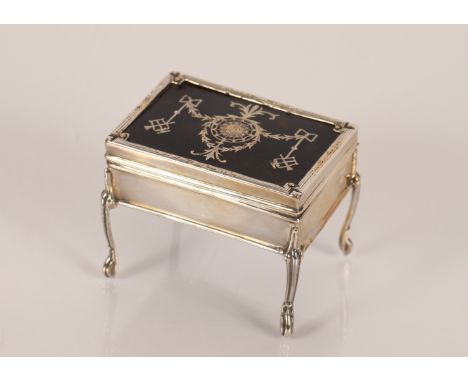 A silver and tortoiseshell trinket box in the form of a writing desk with garland and swag decoration by William Comyns, Lond