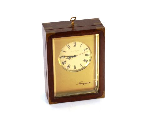 A Patek Philippe Geneve Naviquartz clock, model E1200 No.180400C in mahogany and brass bound case, 23cm high x 17cm wide 