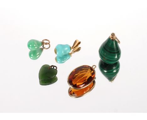 A collection of yellow metal mounted stone set pendants including malachite, jade and citrine