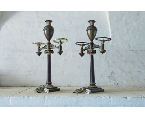 A pair of bronze twin-branch library lamps, mid-19th century, by Miller and Sons, Piccadilly, each surmounted by an urn on a 