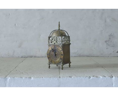 A small 17th-century-style brass lantern timepiece,  c.1920, the 4¾-inch dial with Roman numerals, housing a French eight-day