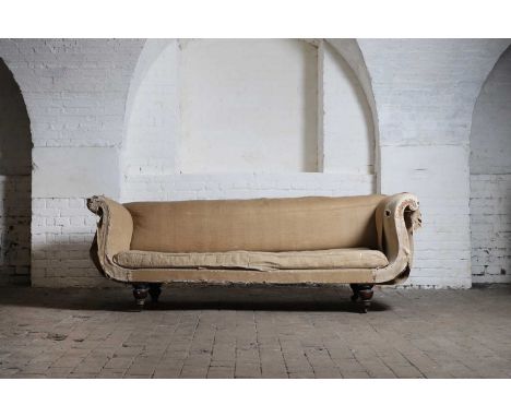 A late Regency sofa, c.1820, with low back and scroll ends over a loose cushion seat, raised on faux rosewood turned legs and