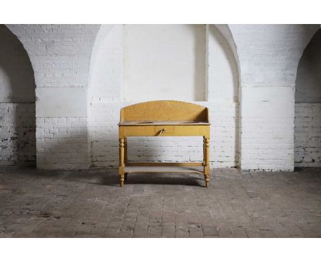 A Victorian scumbled pine washstand, late 19th century, with a shaped three-quarter gallery over two basin apertures, with a 