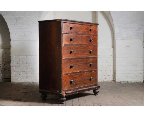 A mahogany chest of drawers, early to mid-19th century, with five long graduated drawers, each with turned knobs, flanked by 
