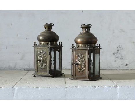 A pair of brass lanterns, 19th century, Dutch, each with a swing handle over a domed top, the single door embossed with a cro