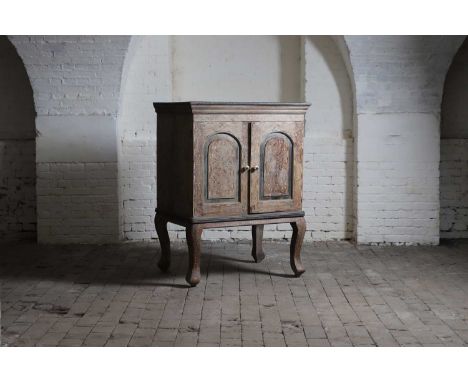 A bone- and ebony-inlaid cabinet on stand, 20th century, Indian, the panelled doors enclosing a shelf, raised on cabriole leg
