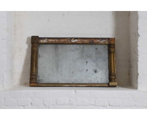 A giltwood overmantel wall mirror. c.1830, the rectangular plate with half-column moulded surround, some mouldings detached,8