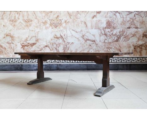 A large oak refectory table, 19th century, the plank top raised on end supports, terminating in sledge feet,275cm wide96cm de