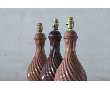A pair of Holkham Pottery simulated porphyry table lamps, second half of the 20th century, each of wrythen baluster form, on 