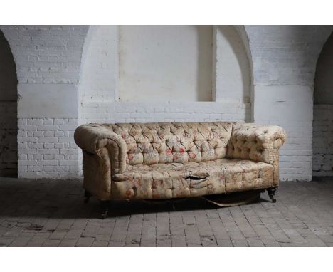 A Victorian three-seater chesterfield sofa, with ring-turned mahogany front legs and brass and ceramic castors,194cm wide86cm