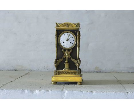 A French Empire ormolu cased mantel clock, 19th century, the eight-day movement striking on a bell, with an enamel dial indis
