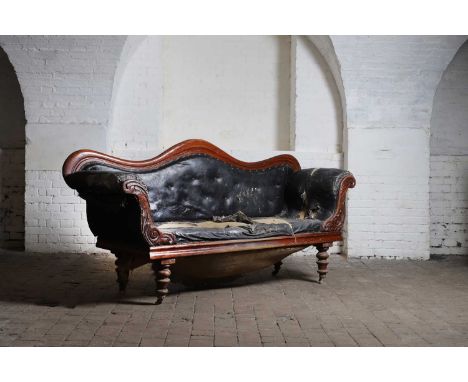 A mid-Victorian mahogany framed sofa, 19th century, with carved show wood and scroll ends, upholstered in leather cloth and r