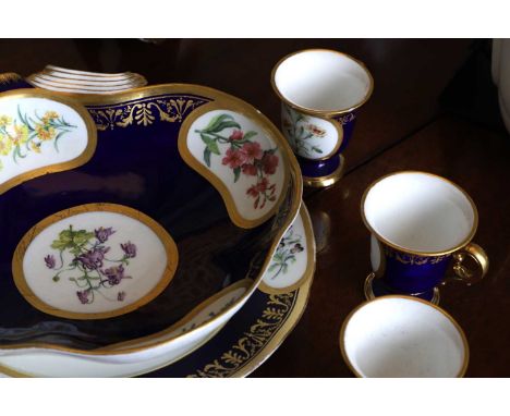 A Republican Sèvres porcelain 'beau bleu' dessert service,  c.1800, each piece with gilt-heightened painted panels enclosing 