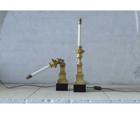 A pair of turned giltwood table lamps, 20th century, each in the form of an urn, on an ebonised square stepped base, one dama