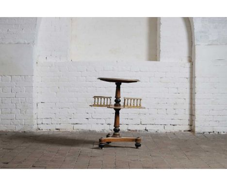 A burr walnut and parcel-gilt bookstand, late 19th century, of circular form with a cruciform galleried undertier, raised on 