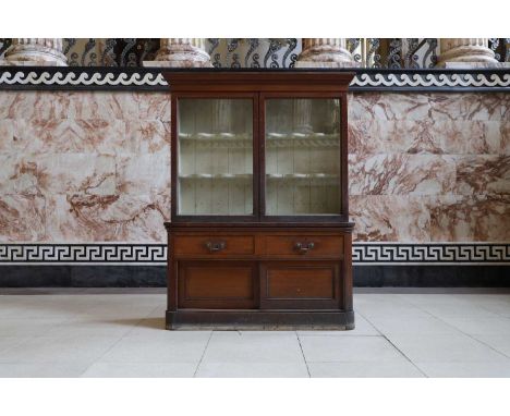 A Holkham Estate oak cabinet, late 19th century, the glazed cupboard with a cream-painted interior, with two shaped and pierc