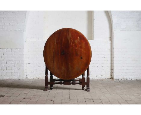 A mahogany circular folding table, 19th century, raised on a turned stand terminating in sledge feet,91cm wide84cm deep70cm h