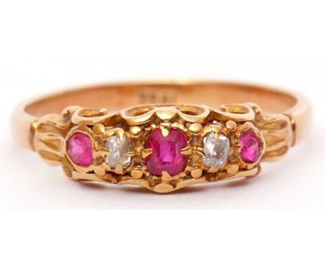 Antique ruby and diamond ring set with 3 graduated rubies and 2 old cut diamonds, all in a carved mount, stamped 18ct, size M