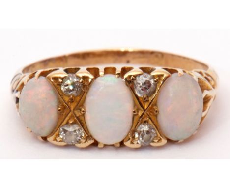 Antique opal and diamond ring, the three oval shaped cabochon opals highlighted with small old cut diamonds, stamped 18 (a/f)