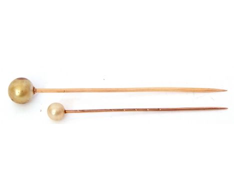 Two yellow metal and simulated pearl stick pins, cased   