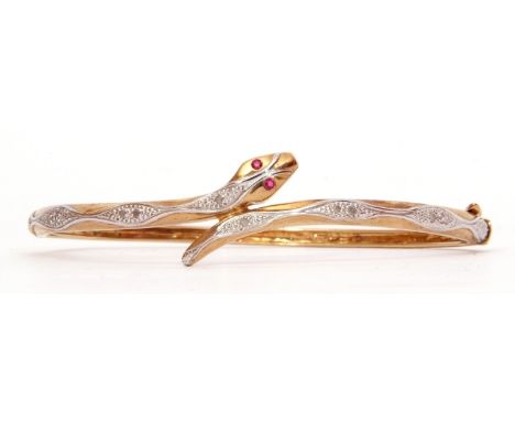 Modern 9ct gold diamond and ruby snake bracelet, hinged design, the serpent with 2 small ruby eyes, the body highlighted with