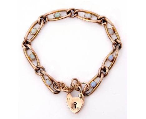 9ct gold curb link bracelet featuring 8 opal links, each centering an oval shaped bezel set opal joined by 9 small plain link