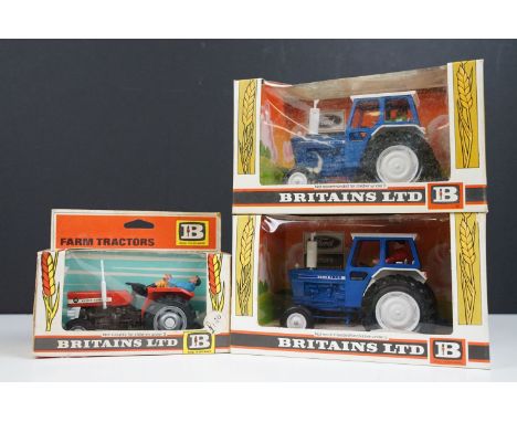 Three boxed Britains farming tractor diecast models to include 2 x 9524 Ford 6600 Tractor blue and white (Both with figures, 