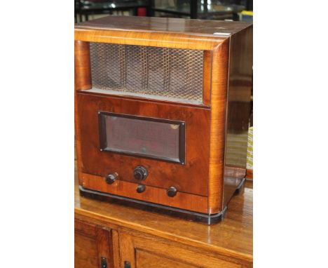 EARLY 20TH CENTURY WALNUT RADIO
made by G Marconi, with central speaker, dial and three turning dials