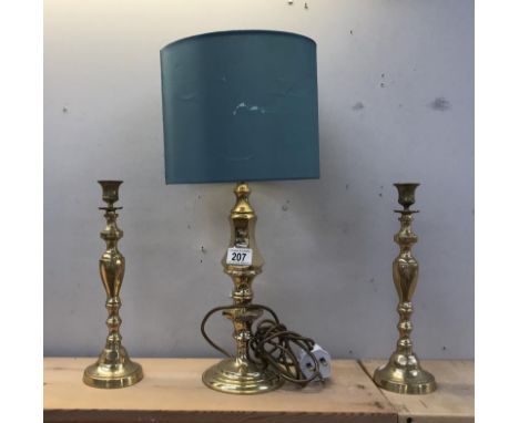 A pair of brass candlestick lamps and a brass table lamp