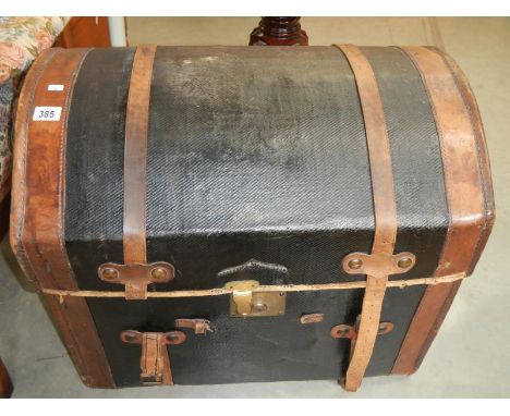A domed leather trunk including upper compartment