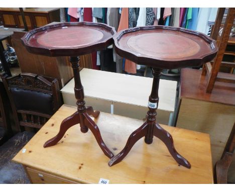 A pair of tripod wine tables with leather inset