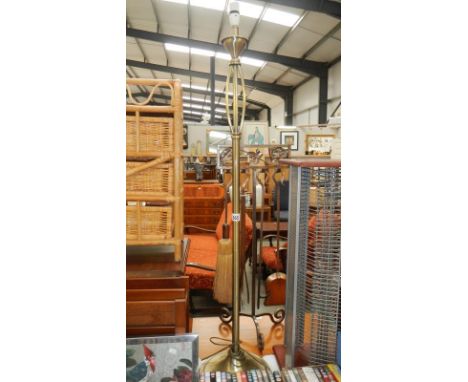 An antique brass finished standard lamp
