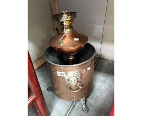 A copper coal bin and a copper oil lamp base