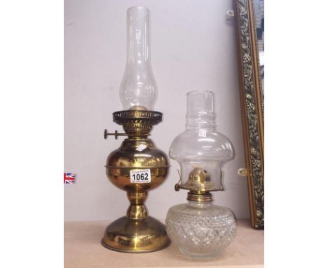 A brass oil lamp and a glass oil lamp