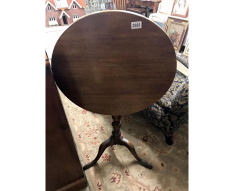 A tip up tripod table