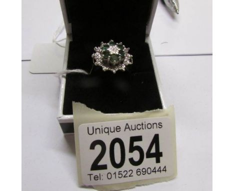 A diamond and emerald cluster ring, circa 1970/1980's, hall marked, size O.