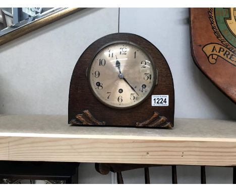 An arch wooden mantel clock