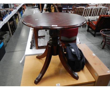 A darkwood stained tripod side table