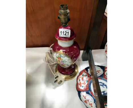 A porcelain urn shaped lamp on gilded brass base