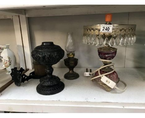 A Victorian spelter oil lamp, boats brass gimbal lamp and 2 others