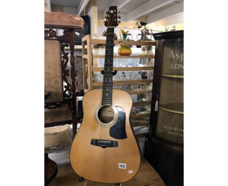 An Aria acoustic model AW100 guitar stand not included
