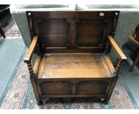 An oak monk's bench with under seat compartment